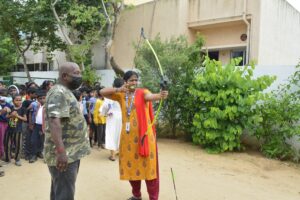 Teacher learning archery from an archer trainer1 at RISHS International School