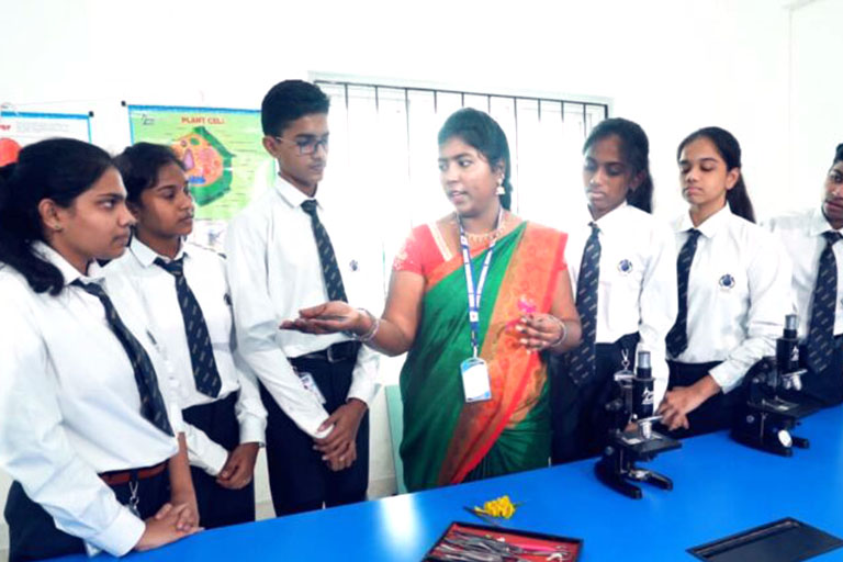 Teacher teaching at Science lab in RISHS International CBSE School Mangadu